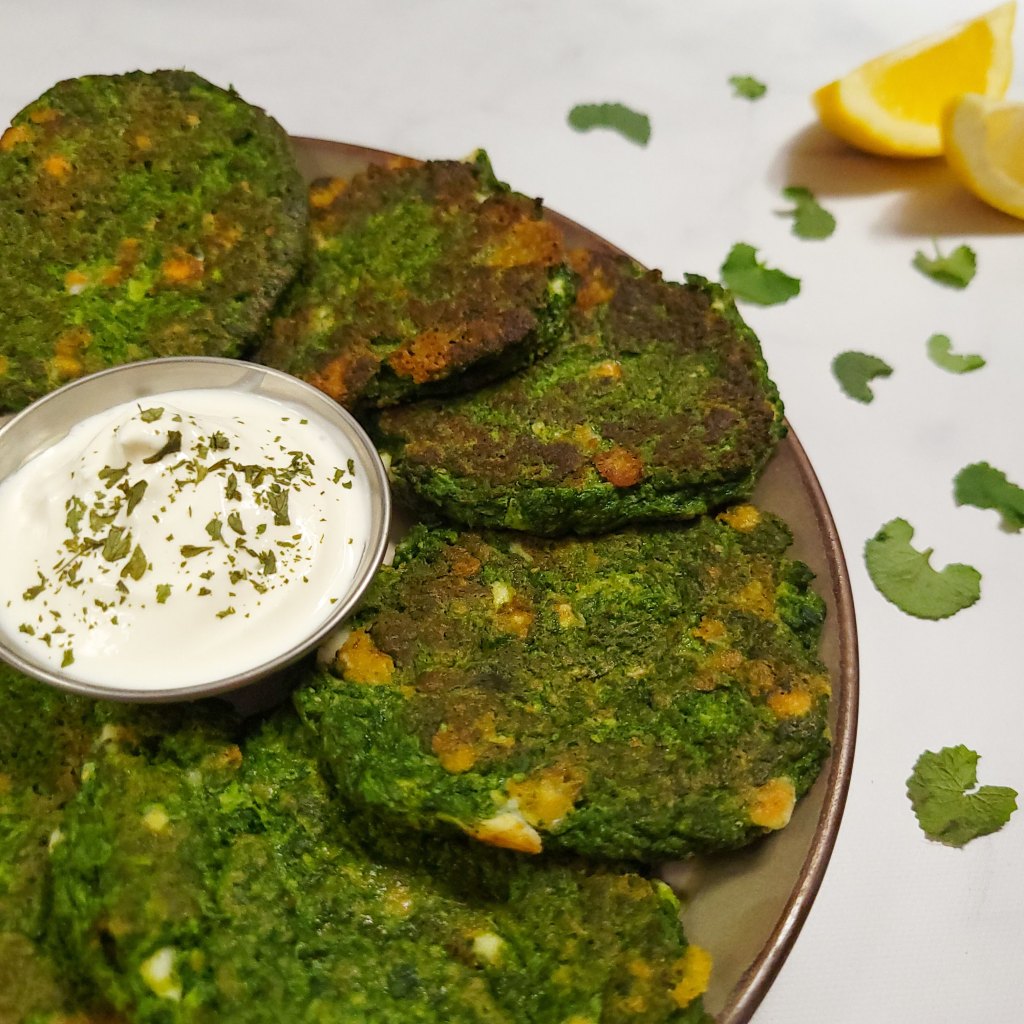 Spring green fritters with a simple sour cream dip and lemon wedges