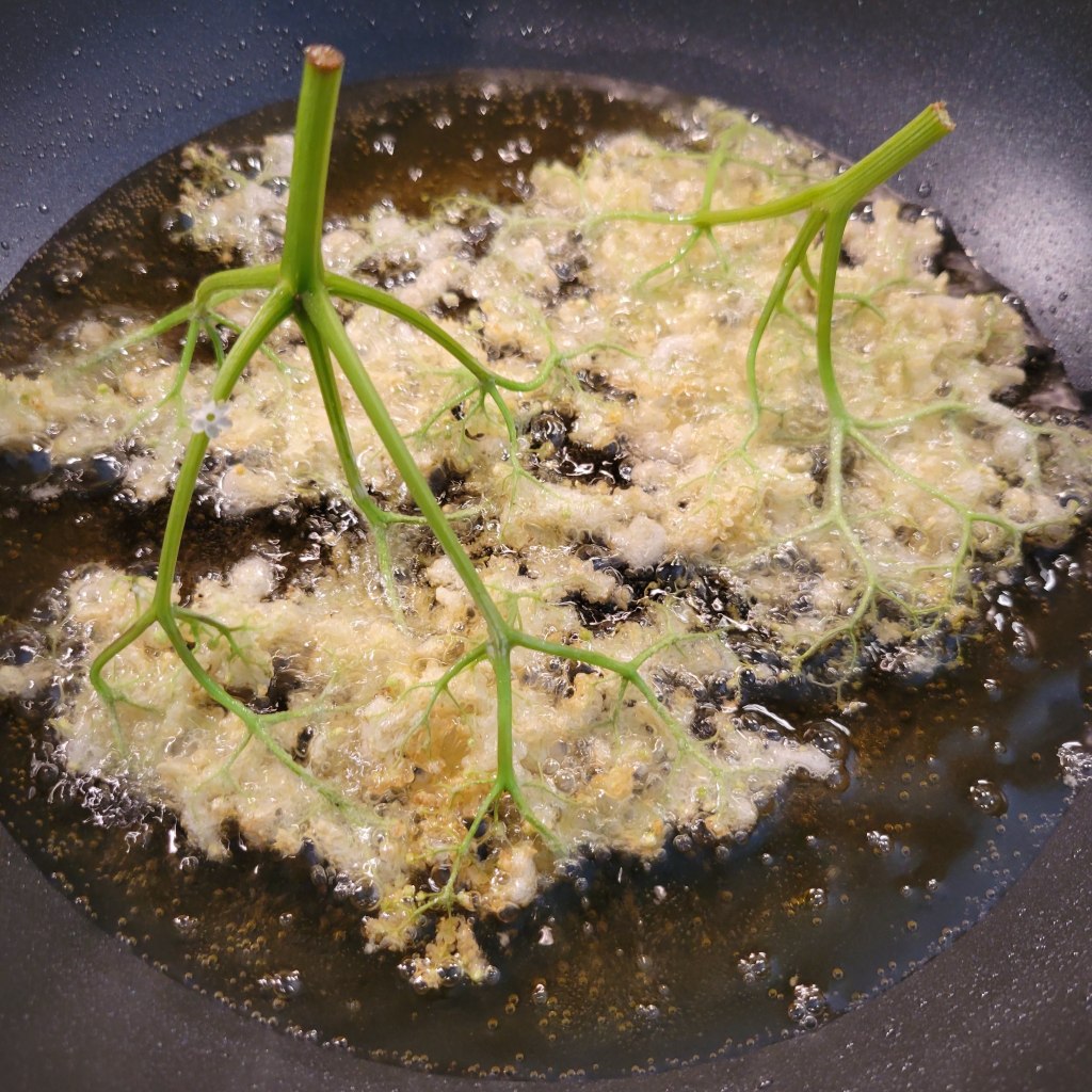 Fry the battered elderflowers in a pan with steep sides